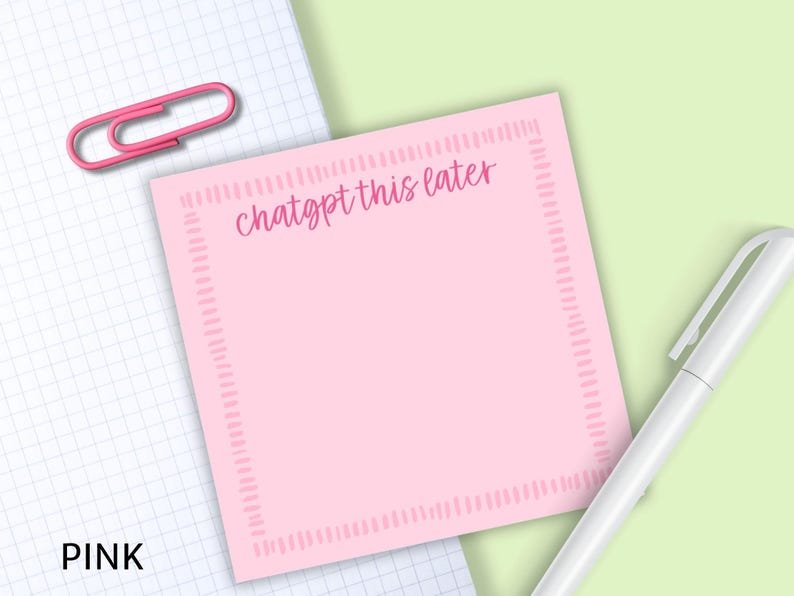 May include: A pink sticky note with the text "chatgpt this later" in a handwritten style. The note has a dotted border and is next to a white pen and a pink paper clip on a grid paper background.