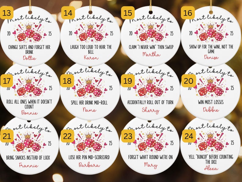 May include: Twelve round white ceramic ornaments featuring a graphic of three red dice with a gold crown, the text Most Likely To, the year 2025, and unique phrases such as Change seats and forget her drink, Laugh too loud, or Win most losses.