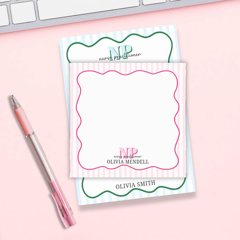 May include: Two pink and blue striped notepads with a scalloped border. The top notepad has the text "NP nurse practitioner" in green and blue. The bottom notepad has the text "NP nurse practitioner OLIVIA MENDEL" in pink and green. The bottom notepad also has the text "OLIVIA SMITH" in green.