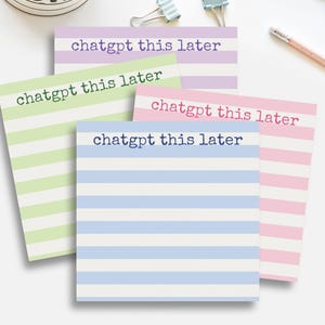 May include: Four square sticky notes with horizontal stripes in pastel colors: green, purple, pink, and blue. Each note has the text "chatgpt this later" in a matching color. The notes are arranged on a white surface.