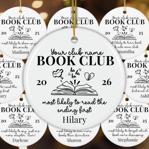 May include: A collection of round white ceramic ornaments featuring black printed text and graphics. Each ornament displays the words BOOK CLUB, a year, an open book illustration, a thought bubble with ha ha, a broken heart, and a personalized name.