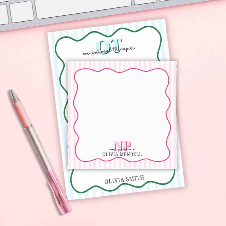 May include: A pink and white striped notepad with a pink scalloped border, with the text "NP nurse practitioner OLIVIA MENDELL". A second notepad with blue and white stripes and green scalloped border has the text "OT occupational therapist OLIVIA SMITH". A pink pen is on the left.