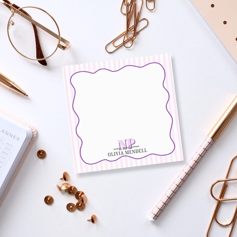 May include: Pink and purple striped notepad with a purple border and the text "NP nurse practitioner Olivia MendeLL" in black and purple text.