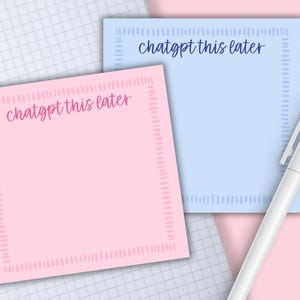 May include: Two sticky notes, one pink and one blue, with the text "chatgpt this later" in cursive. A white pen rests on a pink and white grid background. The notes have a dotted border.