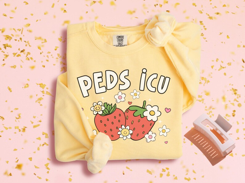May include: Yellow sweatshirt with a graphic of two strawberries and the text "PEDS ICU".