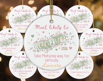 May include: A collection of round white ceramic ornaments featuring illustrations of mahjong tiles and dice. Each ornament displays the text Most likely to, a unique phrase, the year 2025 or 2026, and a personalized name in pink and orange script.