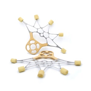 May include: Two silver and wood fire poi sets with yellow wicks. The poi are arranged in a star shape with the wicks pointing outwards.