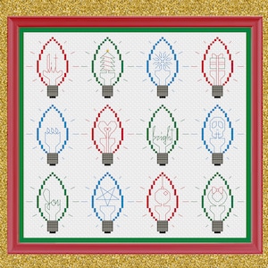 Pode incluir: Uma bordado em ponto cruz emoldurado com doze lâmpadas com vários desenhos e as palavras "lit", "bright" e "joy". As lâmpadas são vermelhas, verdes e azuis, sobre um fundo branco, emolduradas em vermelho e verde.