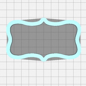 May include: A gray label with a light blue border. The label has a wavy, scalloped edge.