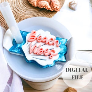 May include: A white and blue seashell-shaped tumbler charm with the text "Beach Vibes" in pink lettering. The charm is designed to fit on a tumbler lid.