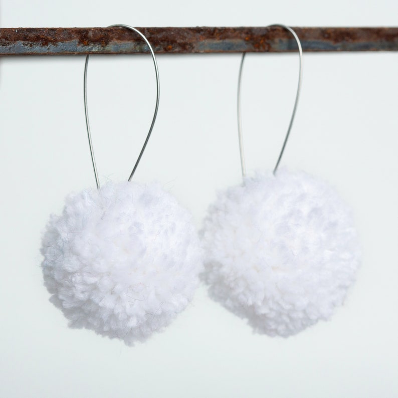 white pom pom earrings