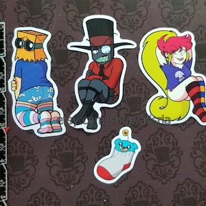 May include: A set of five cartoon character stickers. The stickers showcase various characters, including a figure with a paper bag head, a character in a red suit, and a character with pink hair. The stickers are set against a patterned background.