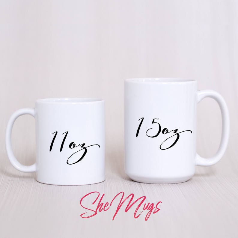 May include: Two white ceramic mugs with black lettering. The smaller mug is 11 oz and the larger mug is 15 oz.