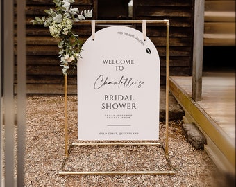 May include: A white sign with a gold frame and a gold arch at the top. The sign says "Welcome to Chantelle's Bridal Shower" with the date "Tenth October Twenty Four" and the location "Gold Coast, Queensland".