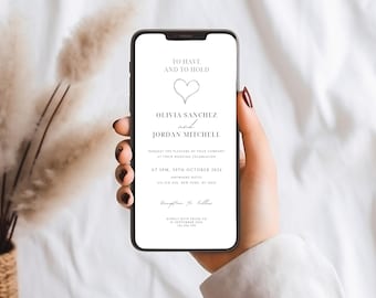 Puede incluir: Un teléfono inteligente muestra una invitación de boda con el texto "TO HAVE AND TO HOLD" y los nombres Olivia Sanchez y Jordan Mitchell. La invitación detalla la fecha, hora y lugar de la boda. El teléfono está en una mano.