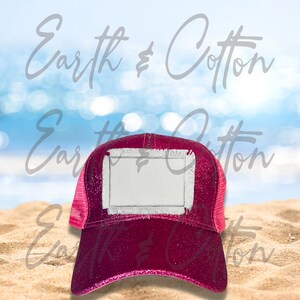 May include: A pink glitter trucker hat with a white patch on the front. The patch has a frayed edge and is blank for customization.