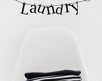 May include: Black and white laundry room wall decal with the word "Laundry" hanging on a string with hearts on either end.