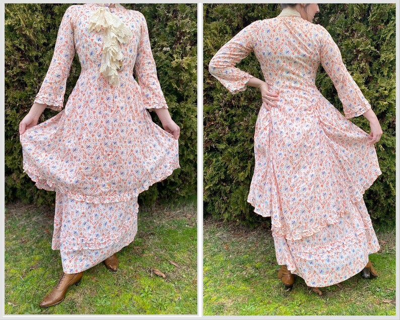 May include: A white dress with a floral print in shades of orange and blue. The dress has a ruffled neckline and long sleeves. The dress is layered and has a tiered skirt.