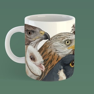 May include: White ceramic mug featuring a colourful illustration of four bird heads. The birds are a brown and white hawk, a brown and white owl, a brown and white hawk, and a black and white bird.