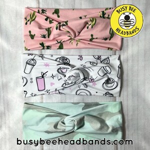 May include: Three different patterned headbands. The top headband is pink with a cactus print. The middle headband is white with a coffee cup and drink print. The bottom headband is light green with a camouflage pattern. The headbands are all tied in a knot. The text "Busy Bee Headbands" is on a yellow circle with a bee in the center.