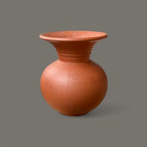 May include: A terracotta vase with a wide, flared opening and a rounded body. The vase has a smooth, matte finish and is a rich, reddish-brown colour.