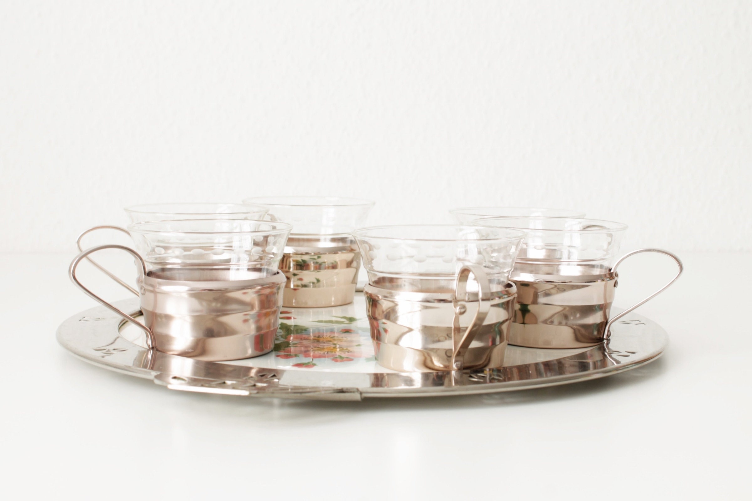 glass and metal tea cups