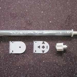 May include: A white spring roller blind mechanism with a metal spring, two white brackets, and a white plastic winding knob.