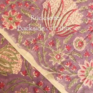 May include: Close-up of a floral fabric with a purple background. The fabric features large, stylized flowers in shades of pink, red, and green. The text "Backside of Fabric" is visible on the fabric.