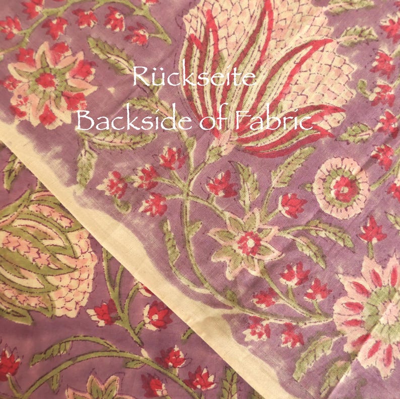 May include: Close-up of a floral fabric with a purple background. The fabric features large, stylized flowers in shades of pink, red, and green. The text "Backside of Fabric" is visible on the fabric.