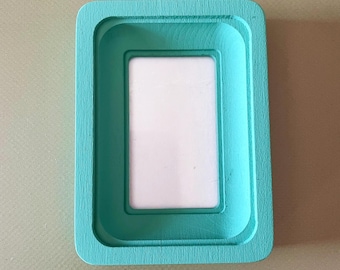 turquoise rectangular frame,frame on the wall