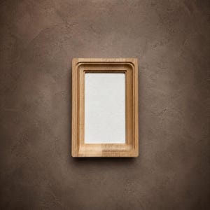 May include: A rectangular light-toned wooden picture frame with a stepped, layered border design. The frame features a smooth, natural wood grain finish and surrounds a plain, white, rectangular center insert for displaying photos.