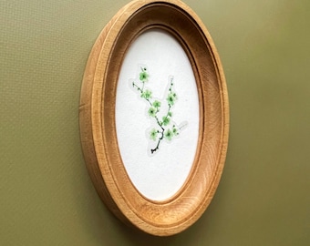 light brown wooden oval frame