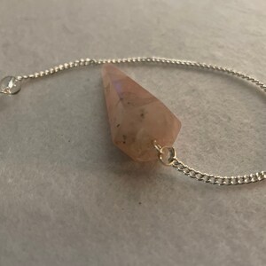 This beautiful Rose Quartz Pendulum is  1.75” and with chain is 8”.