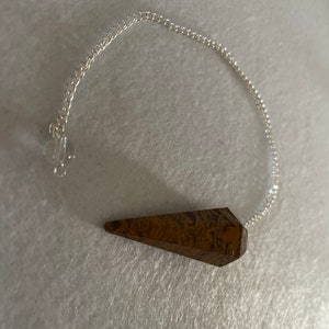 beautiful Yellow Jasper Pendulum is 1.50” and with the chain it is approximately 8”
