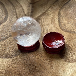 Crystal Clear Quartz crystal ball/sphere is 3.4 oz with the wooden stand.