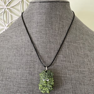 Greenman pendant necklace on black cord.