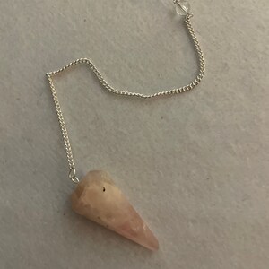 This beautiful Rose Quartz Pendulum is  1.65” and with chain is 8”