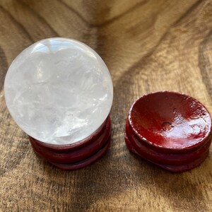 Crystal Clear Quartz crystal ball/sphere is 2.8 oz with the wooden stand.