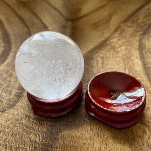 Crystal Clear Quartz crystal ball/sphere is 2.5 oz with the wooden stand.