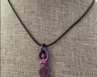 The Goddess pendant necklace on black cord.