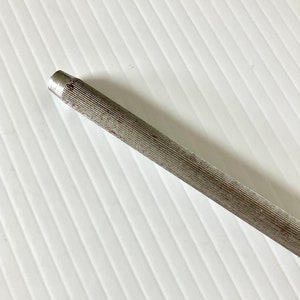 May include: A silver metal file with a ridged surface. The file is used for sharpening tools.