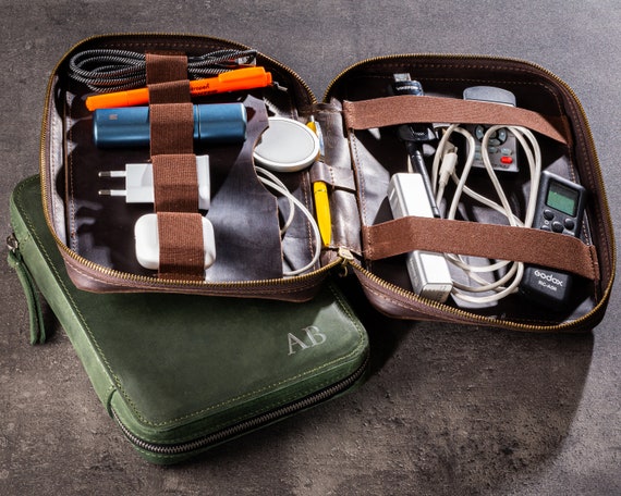 A handcrafted leather tech organizer with 294 favorites and personalization options — the kind of travel accessory that feels premium the moment you unzip it.
