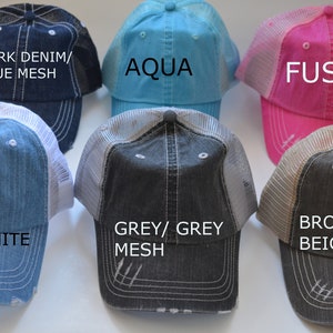 May include: Six different colored baseball caps with mesh backs. The caps are in the following colors: dark denim with blue mesh, aqua, fuchsia, denim with white mesh, grey with grey mesh, and brown with beige mesh.