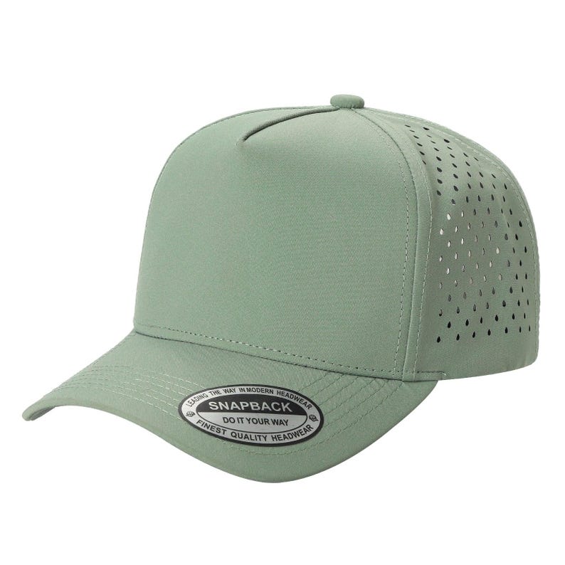 May include: A sage green five-panel snapback cap with a perforated side panel for ventilation. The brim features a circular sticker with the text: LEADING THE WAY IN MODERN HEADWEAR SNAPBACK DO IT YOUR WAY FINEST QUALITY HEADWEAR.
