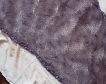 May include: A purple felted shawl with a white pattern and a beaded trim.