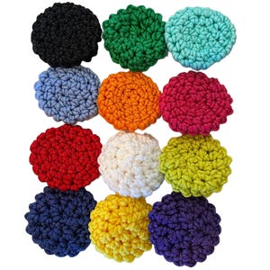 May include: Twelve crocheted round coasters in various colors, including black, green, turquoise, blue, orange, pink, red, white, yellow, lime green, navy blue, and purple.