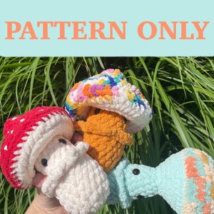 May include: A collection of colorful, crocheted mushroom figures. One mushroom is red with white spots, another is white, a third is orange, and the last is light blue with a patterned top. The text "PATTERN ONLY" is displayed above the mushrooms.