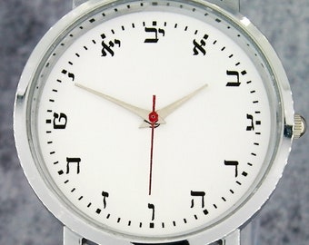 Hebrew numerals custom wristwatch. Minimalist/understated design. Comes with black strap. Unique watch design. White face