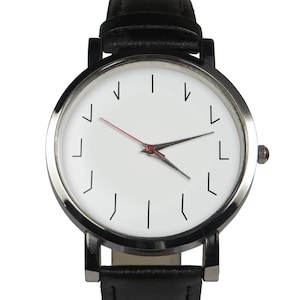May include: A black leather wristwatch with a silver case and a white face. The watch has a unique design with numbers represented by inverted L shapes.