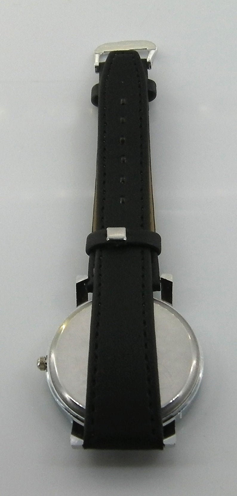 May include: A silver and black wristwatch with a round face and a black leather band.